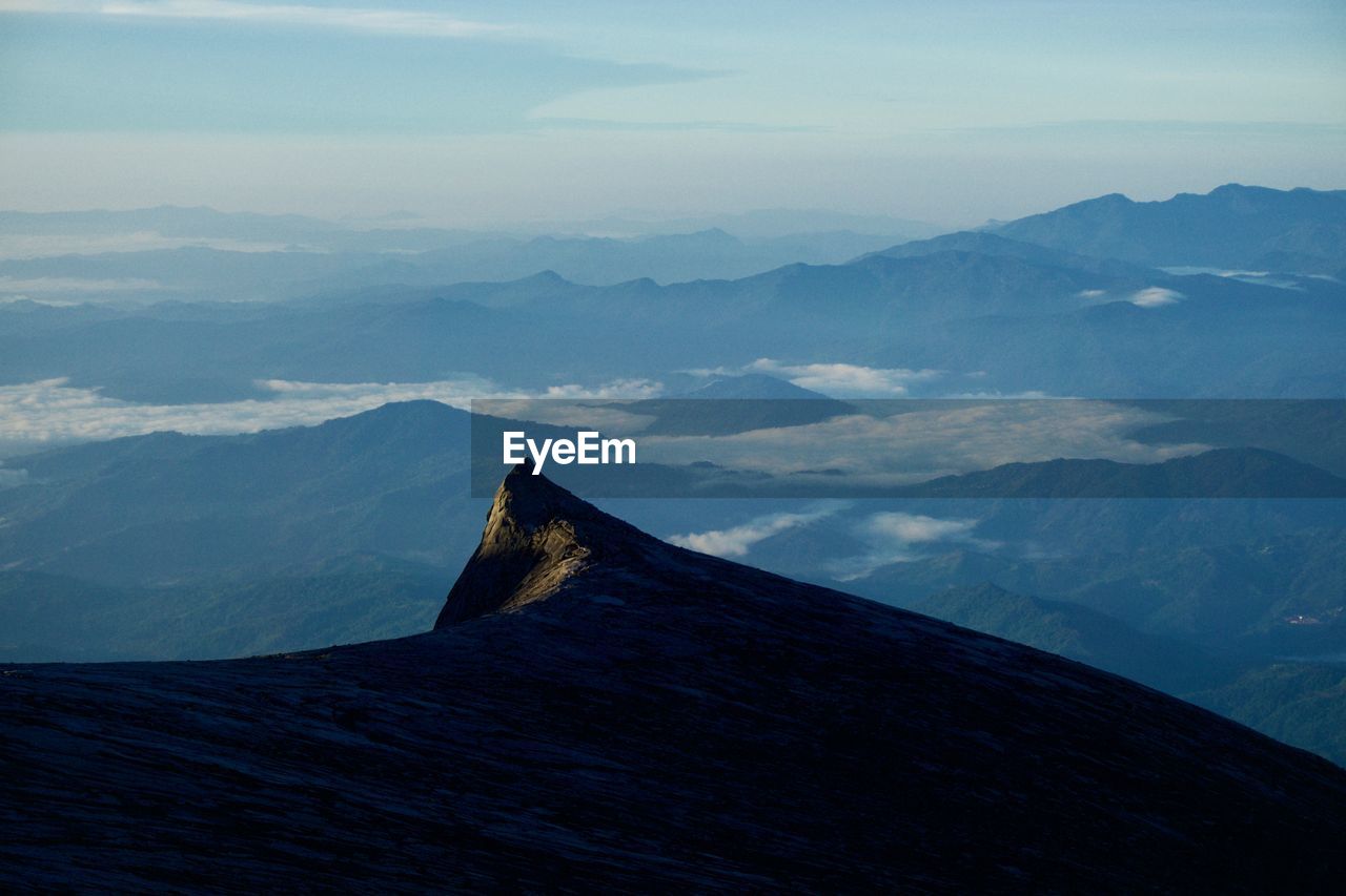 PANORAMIC VIEW OF MOUNTAIN RANGE AGAINST SKY