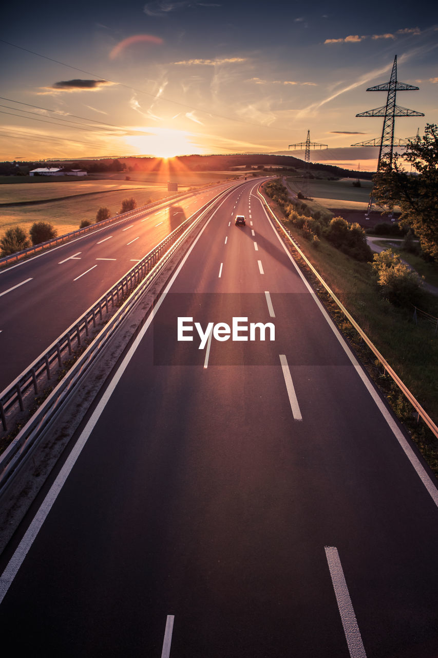 ROAD AGAINST SKY AT SUNSET