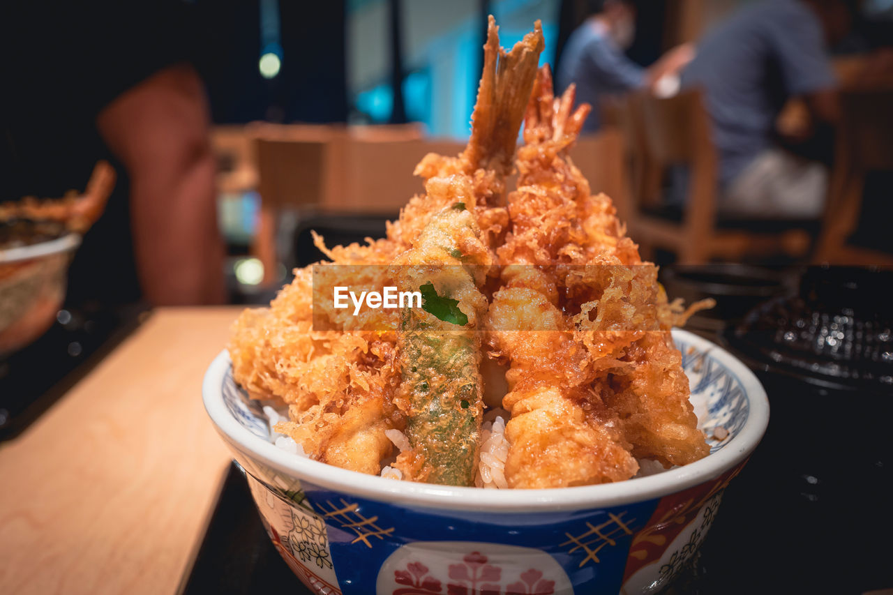 food and drink, food, dish, asian food, cuisine, meal, freshness, focus on foreground, fried, business, table, indoors, restaurant, fried prawn, close-up, japanese food, fried food, tempura, bowl, meat, deep frying, seafood, healthy eating