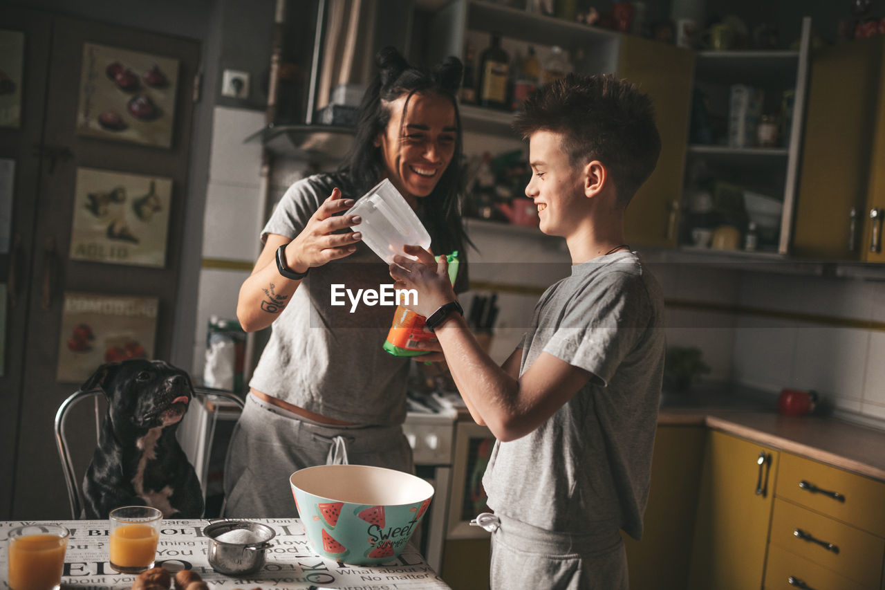 Young man and woman standing at table