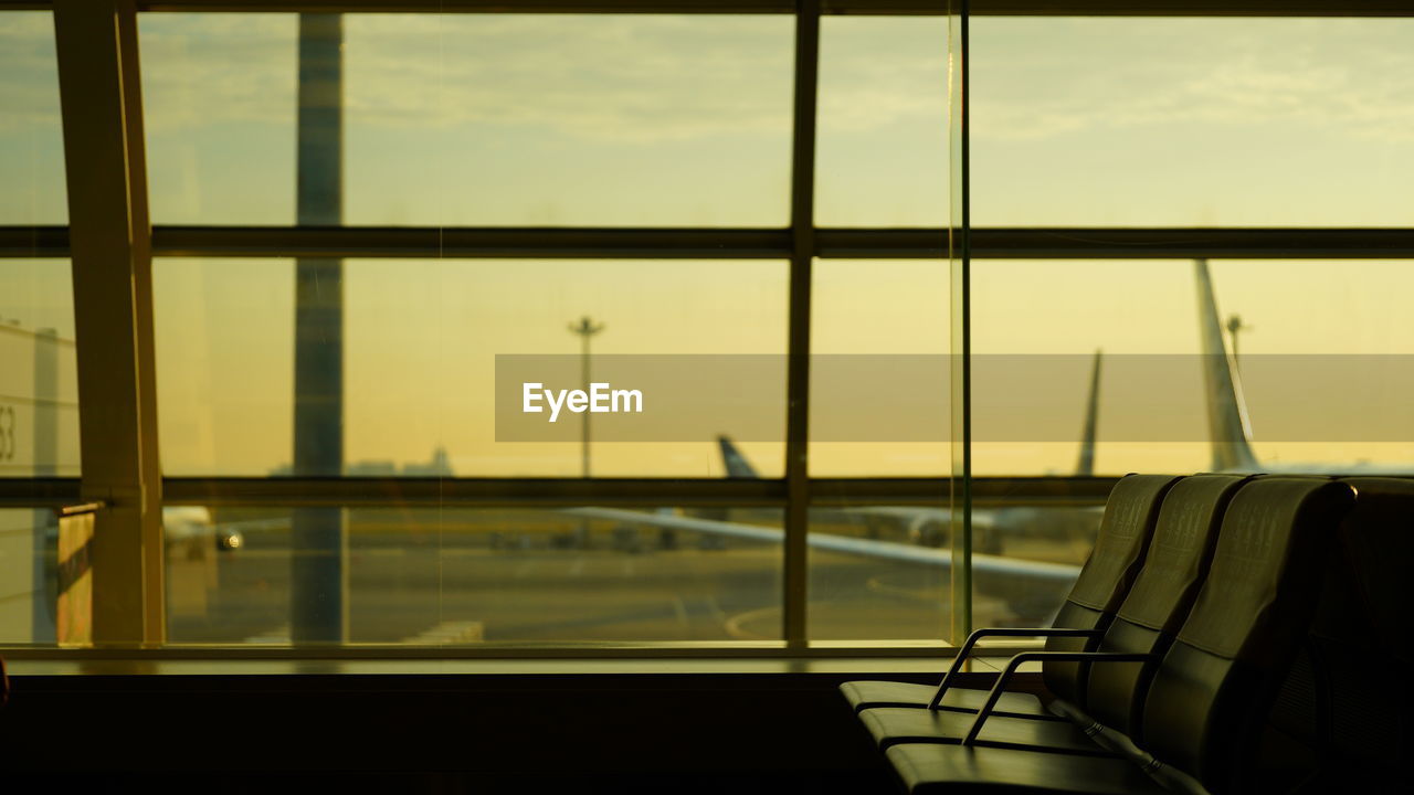 AIRPORT SEEN THROUGH GLASS WINDOW