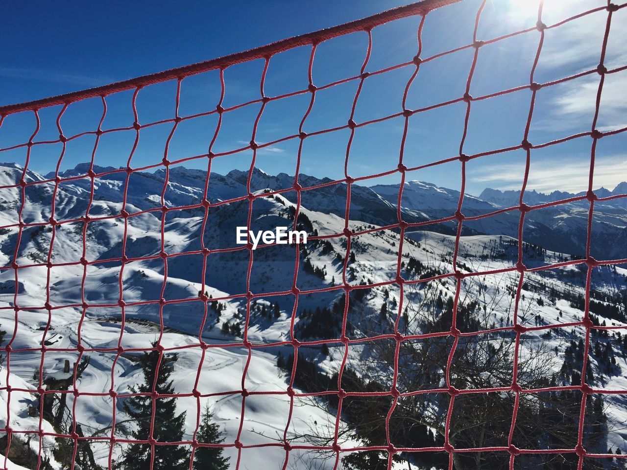 Close-up of net in mountains against sky