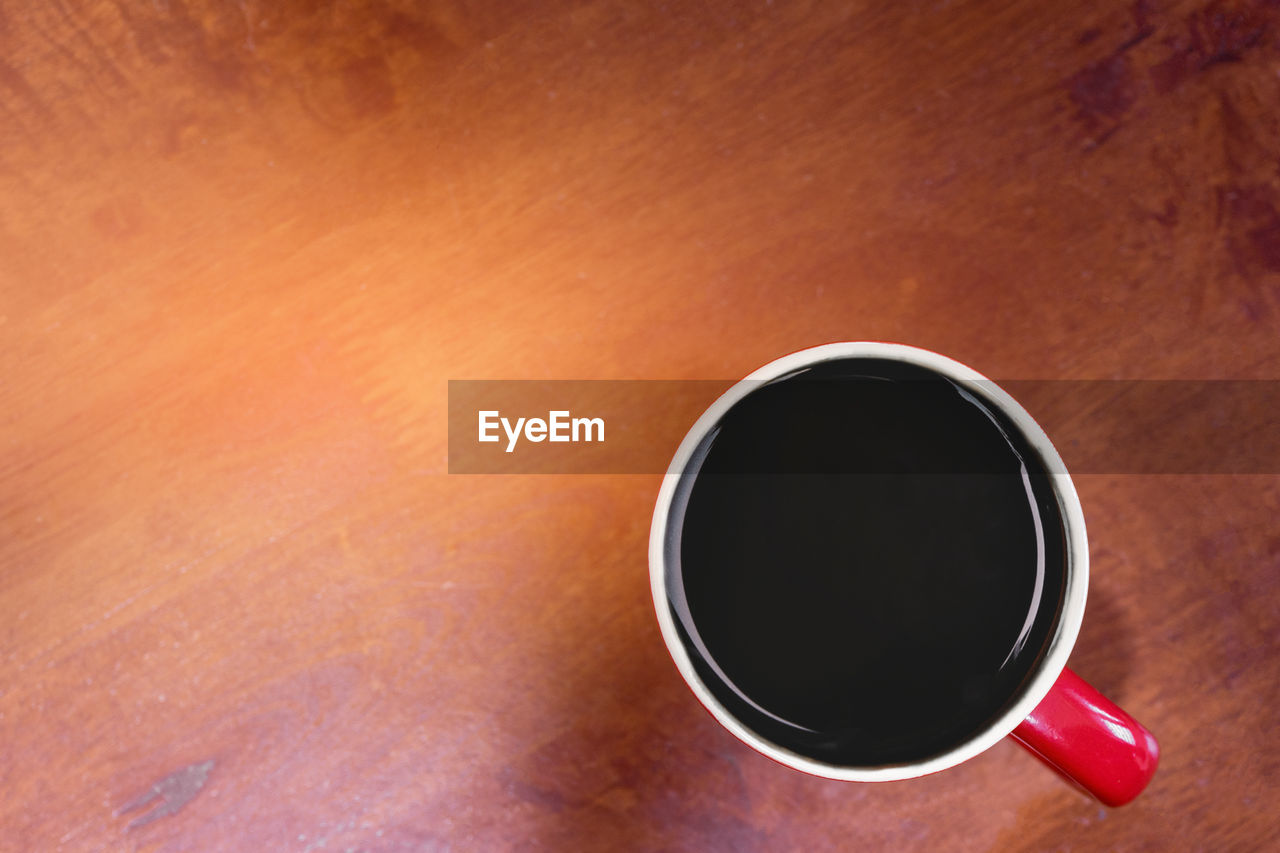 Black coffee on wooden background. copy space, flat lay view.