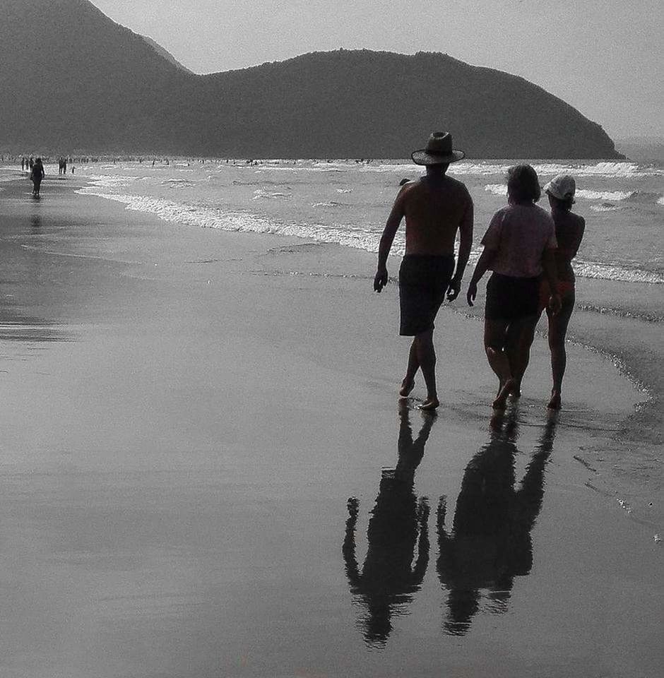 water, sea, beach, land, mountain, nature, group of people, men, walking, sky, leisure activity, adult, lifestyles, rear view, beauty in nature, holiday, reflection, full length, sports, day, trip, vacation, silhouette, coast, women, scenics - nature, outdoors, person, togetherness, travel, small group of people, ocean, water sports, shore, mountain range