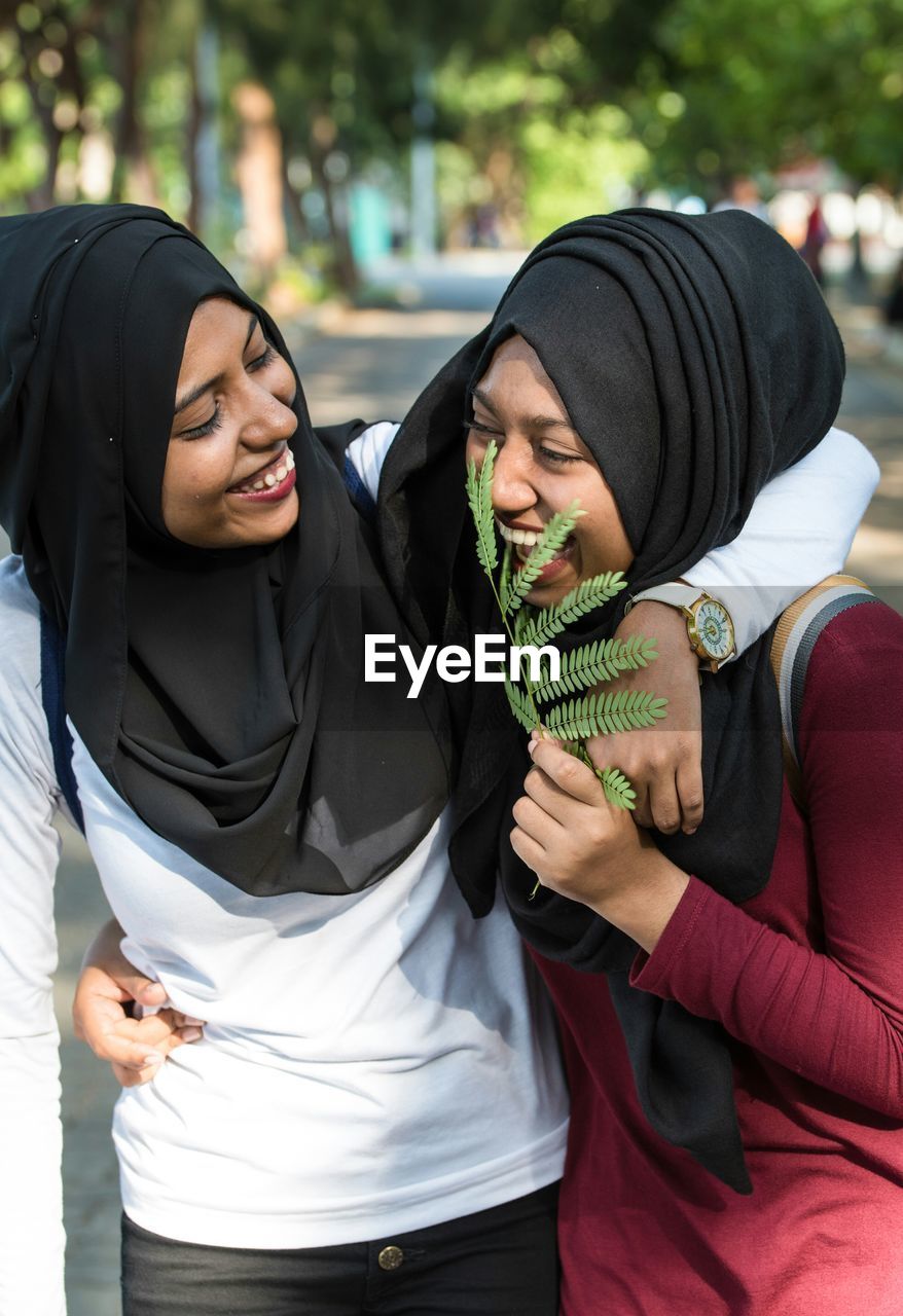 Close-up of happy friends wearing hijab