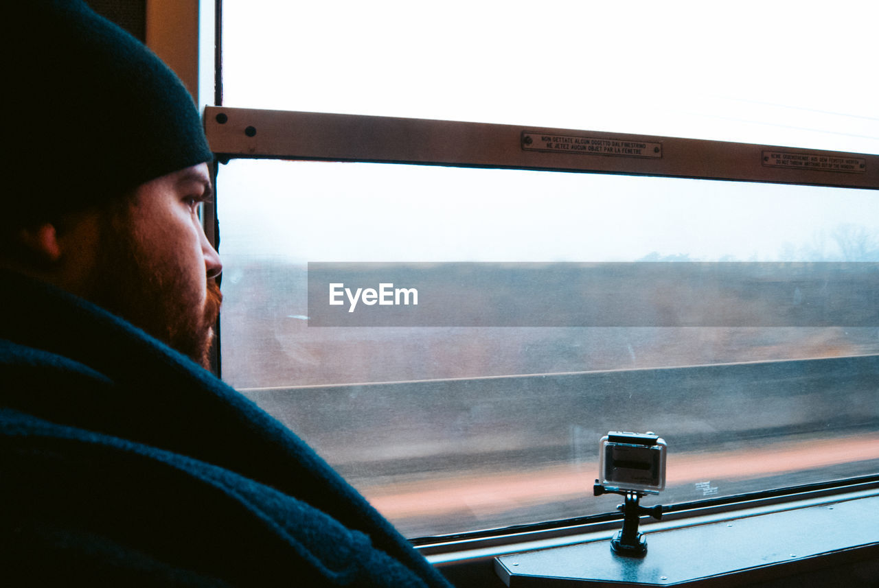Portrait of man seen through train window