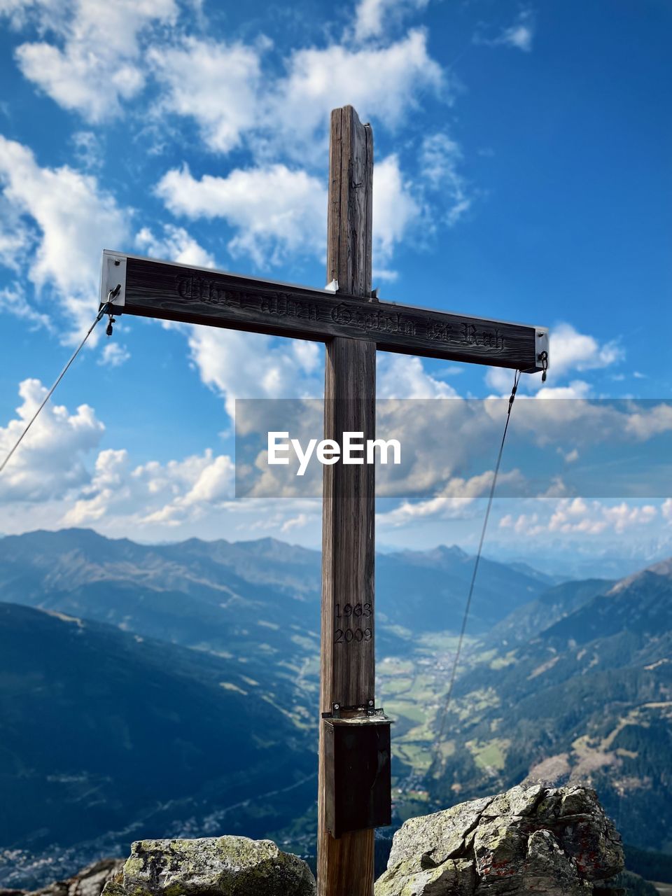 Cross on mountain against sky