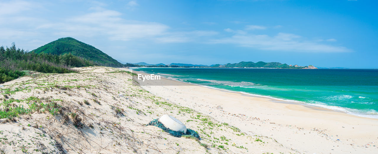 PANORAMIC VIEW OF BEACH AGAINST SKY