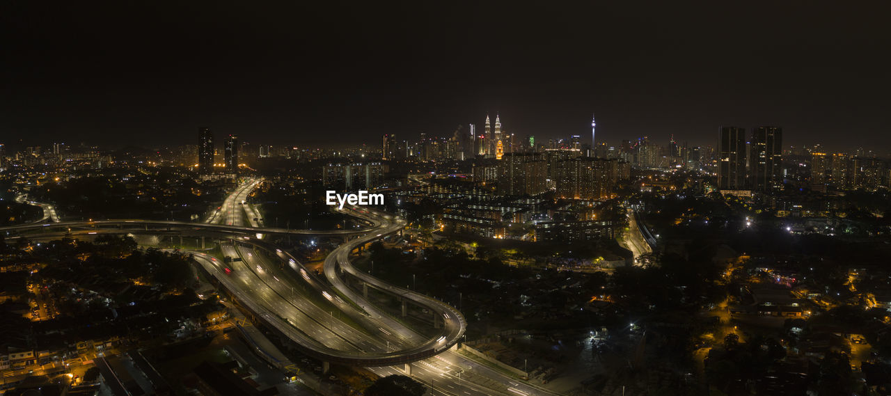 High angle view of city lit up at night