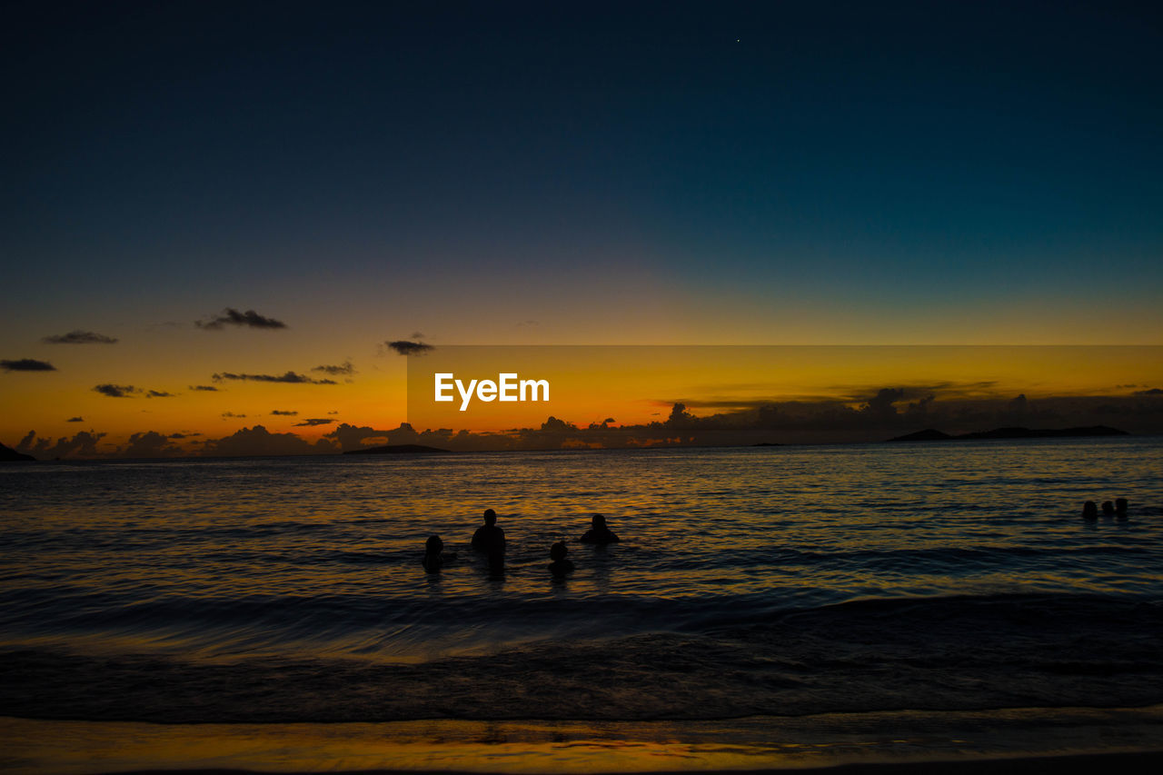 SILHOUETTE PEOPLE AT BEACH DURING SUNSET