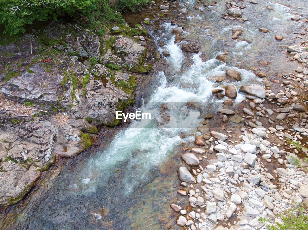 STREAM FLOWING THROUGH ROCKS