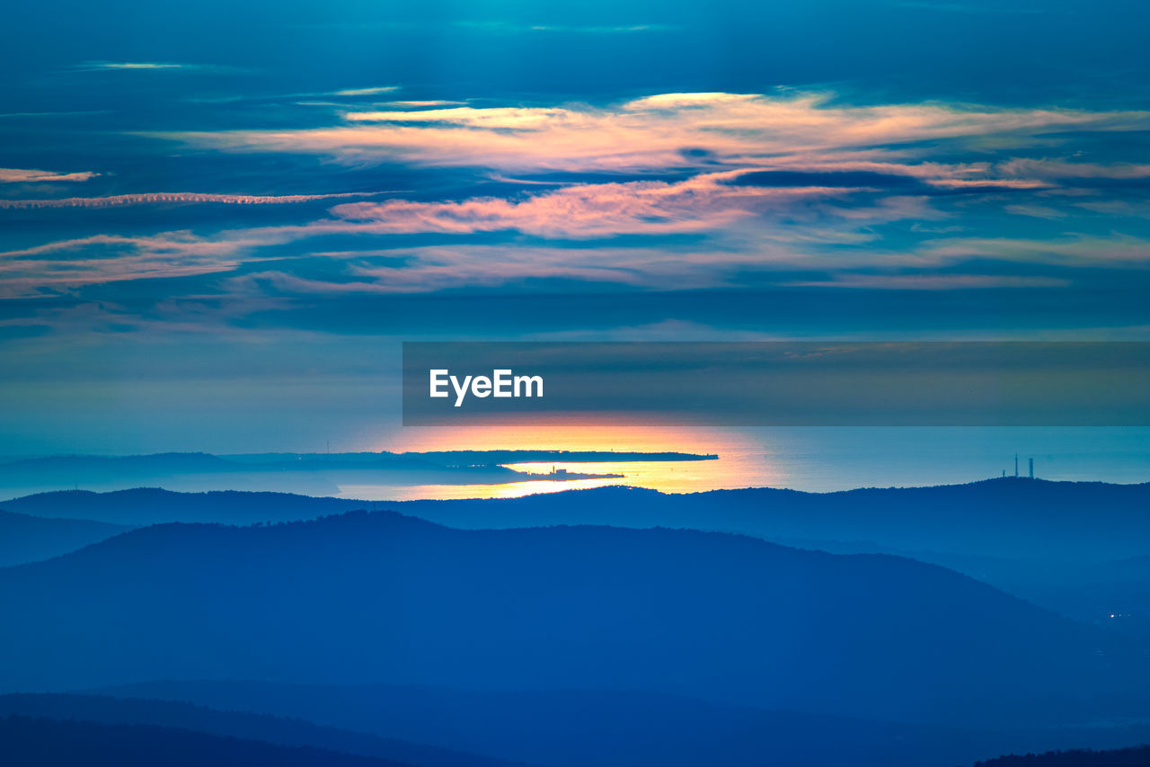SCENIC VIEW OF SILHOUETTE MOUNTAINS AGAINST ROMANTIC SKY