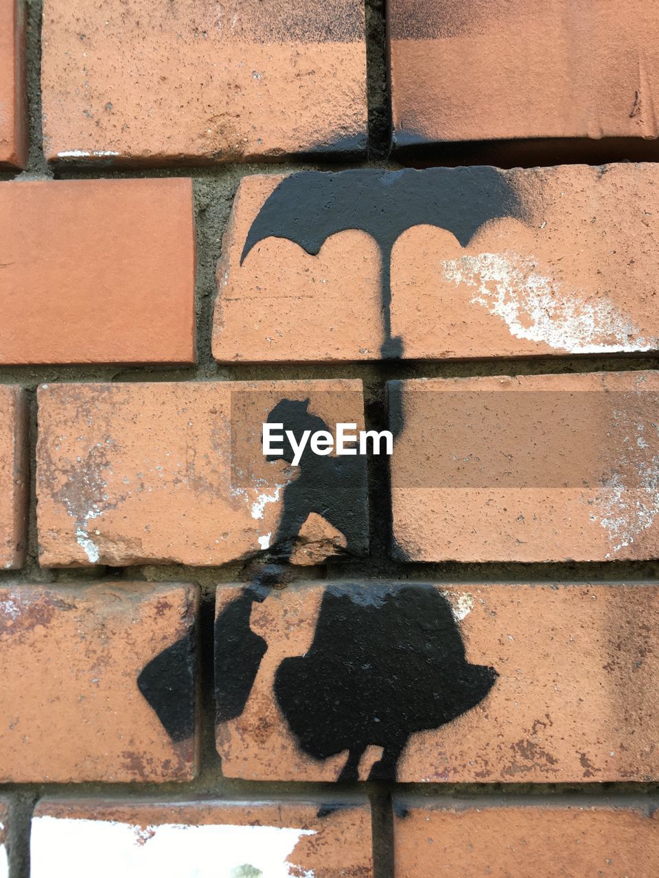 CLOSE-UP OF SHADOW ON BRICK WALL