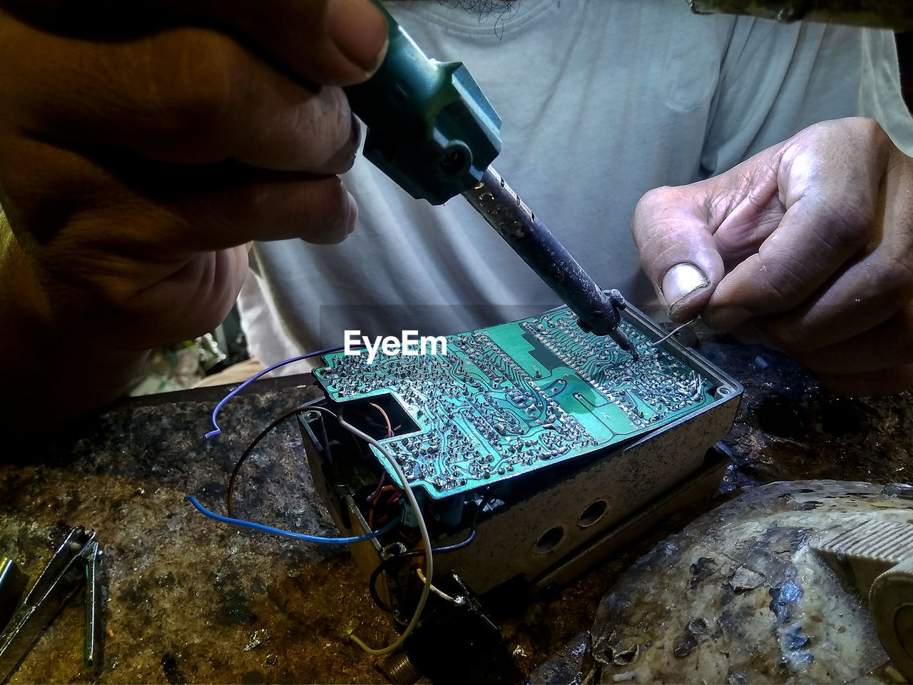 Midsection of technician working at workshop