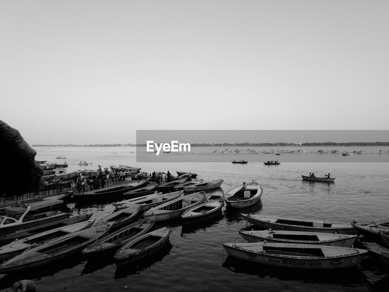 BOATS MOORED ON SHORE AGAINST CLEAR SKY