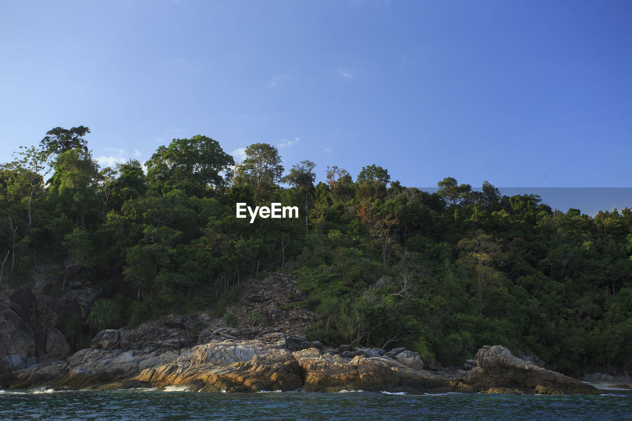 Scenic view of rocks in sea against clear sky