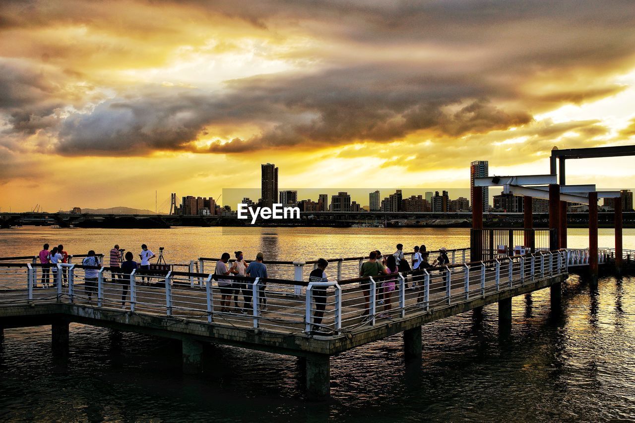 PEOPLE ON PIER AT SUNSET