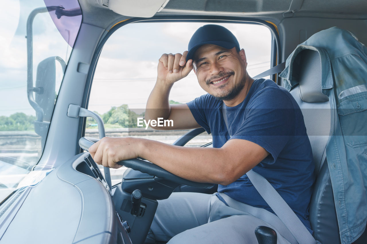 Portrait of man sitting in truck