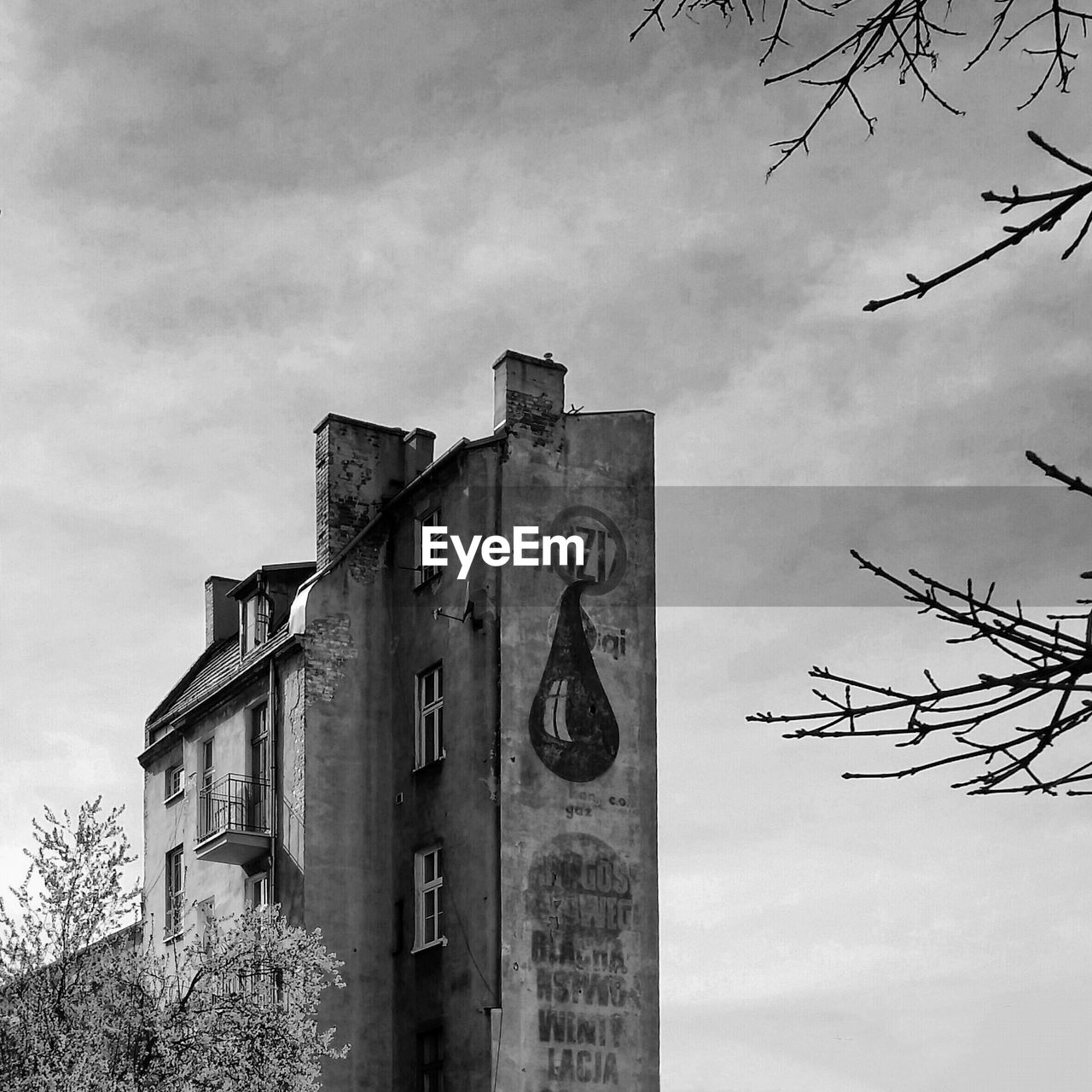 Low angle view of residential building against cloudy sky