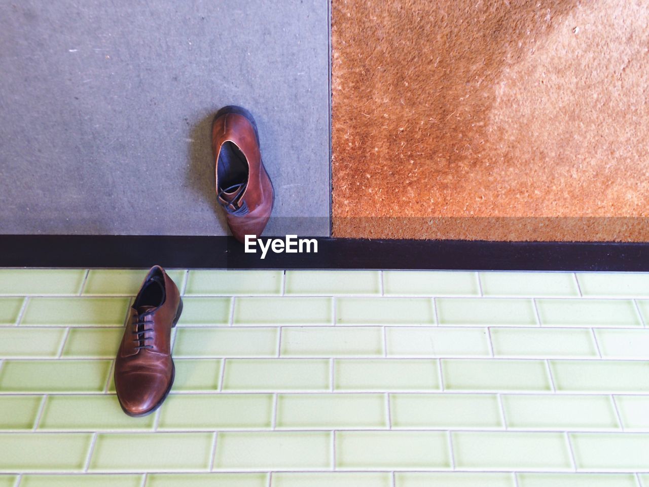 Close-up high angle view of shoes on tiled floor