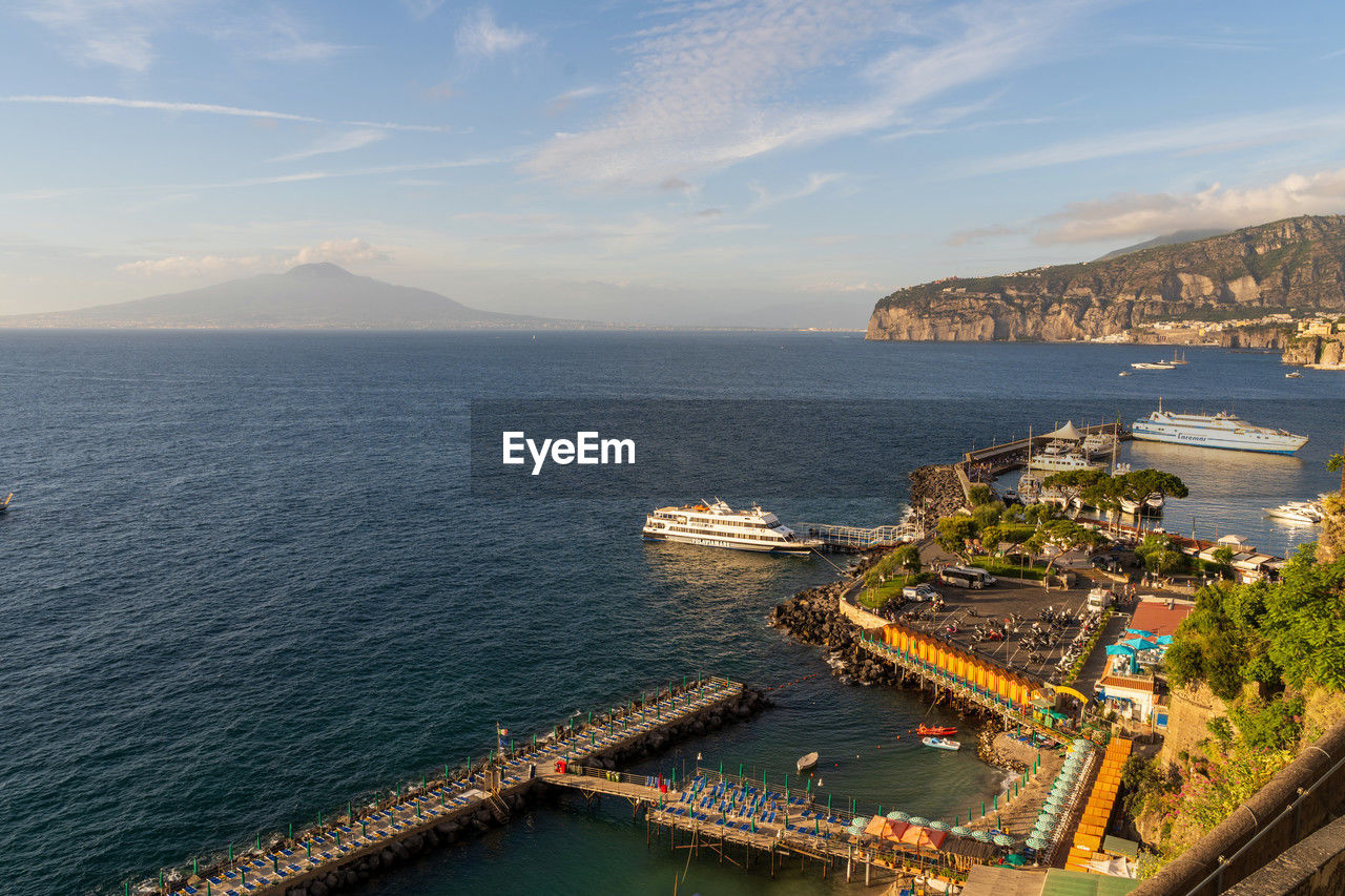 high angle view of city by sea against sky