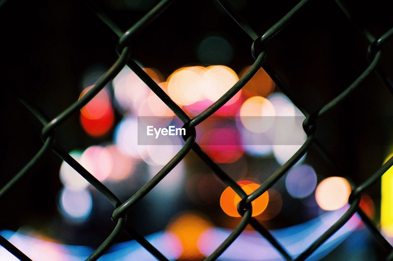 Defocused lights seen through chainlink fence