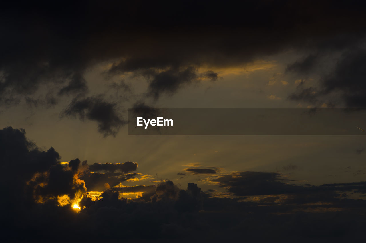 LOW ANGLE VIEW OF DRAMATIC SKY OVER SILHOUETTE LANDSCAPE