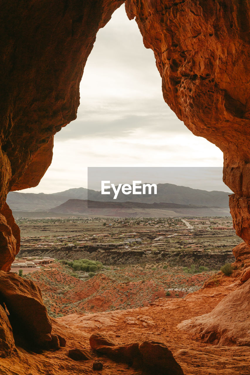 Desert cave entrance overlooking the suburbs of st. george utah