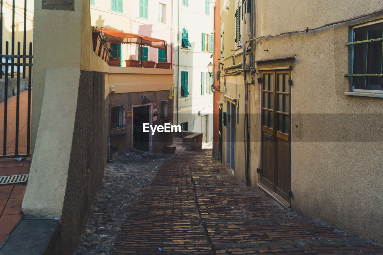 EMPTY ALLEY AMIDST BUILDINGS