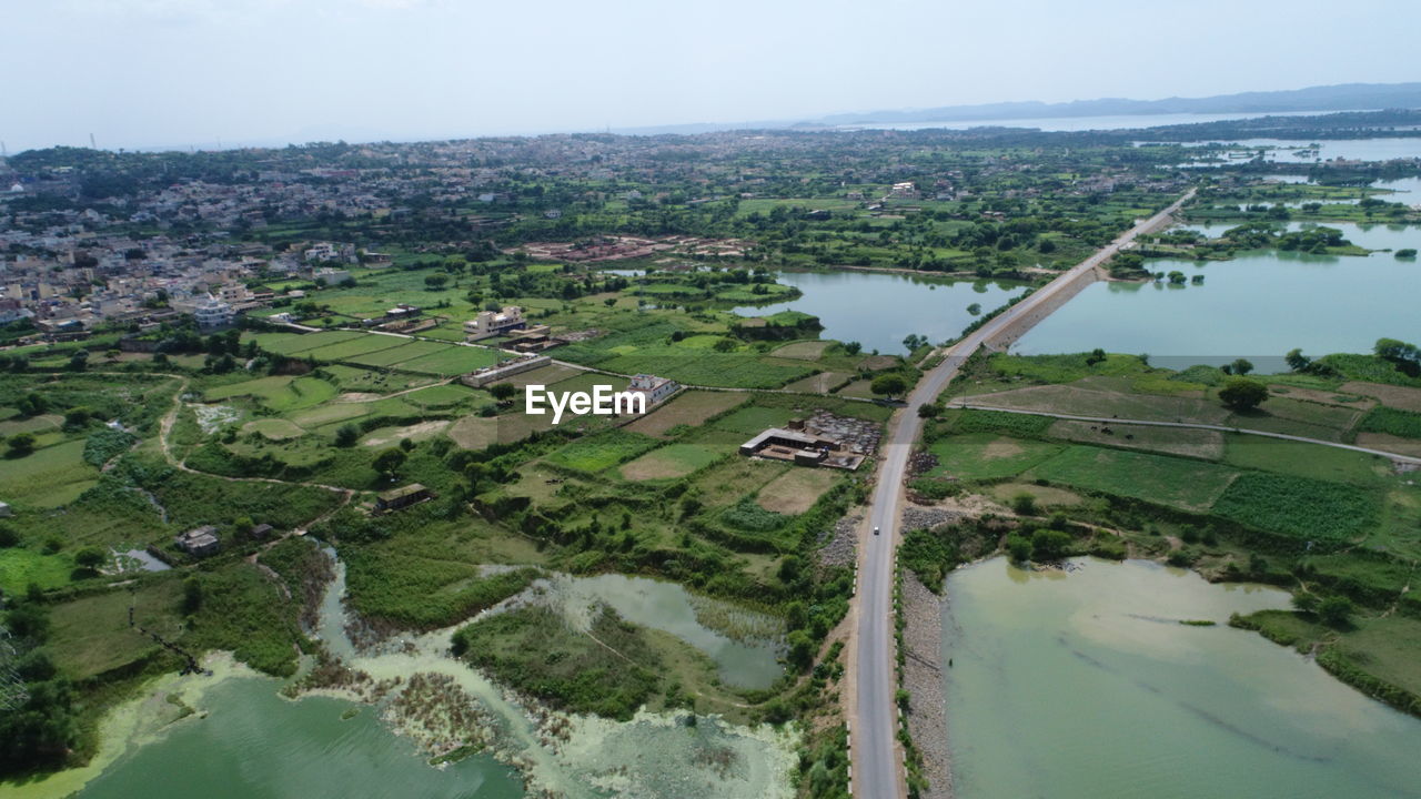 High angle view of river and cityscape against sky