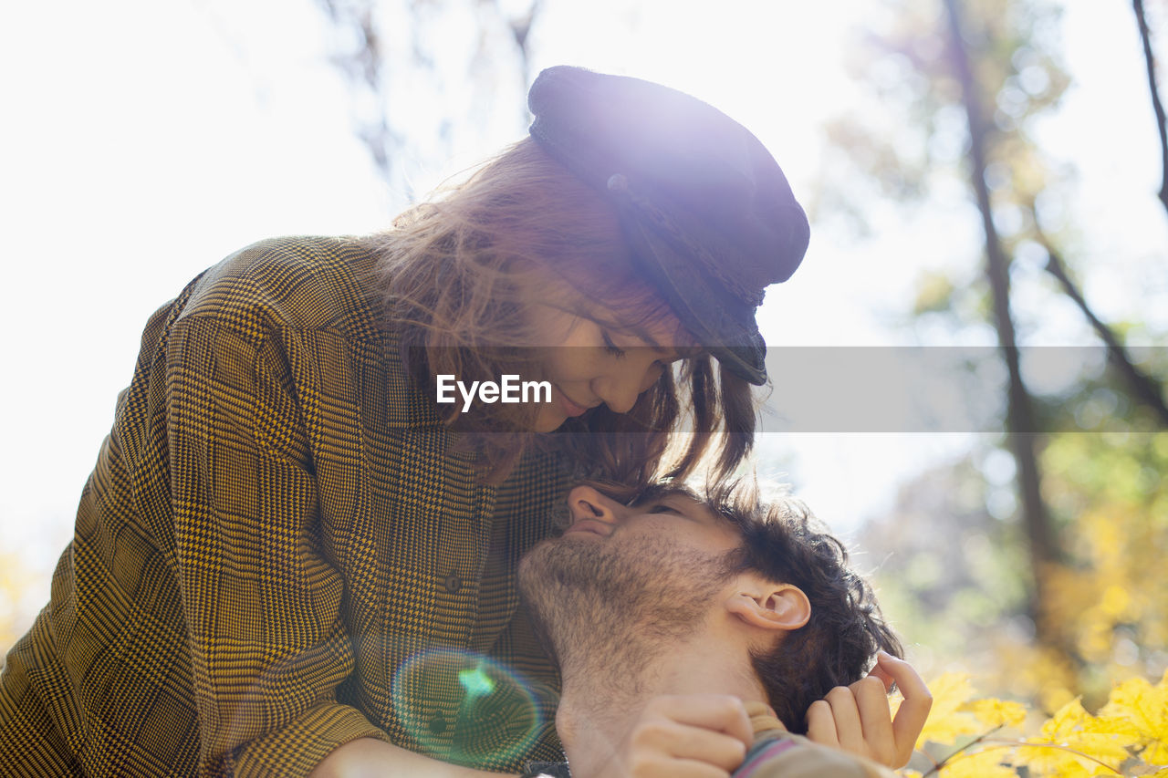 Happy young couple kissing in a park