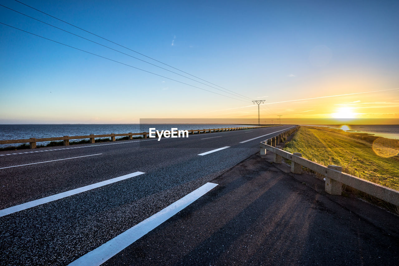 ROAD AGAINST SKY DURING SUNSET