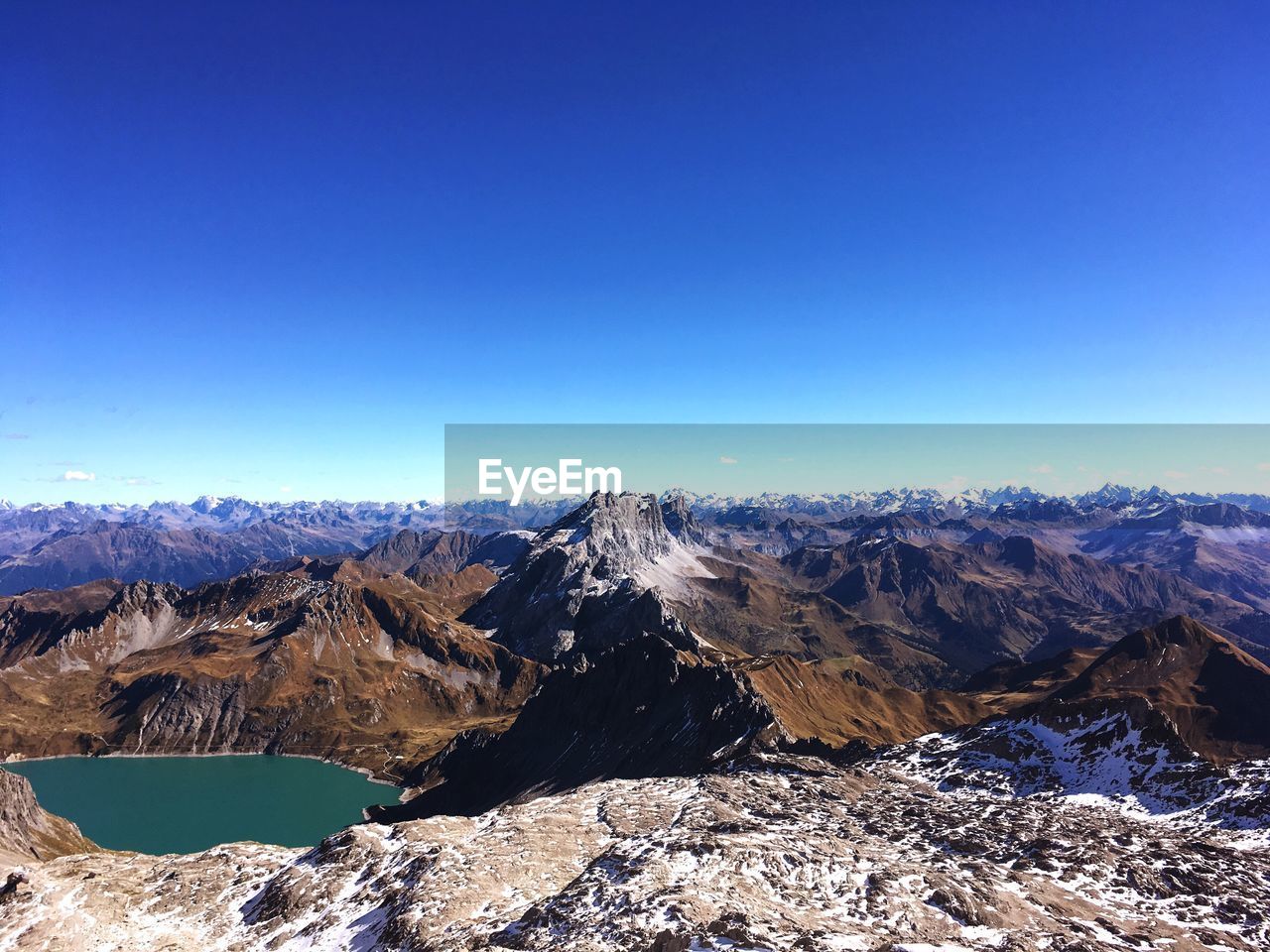 Scenic view of mountains against clear blue sky