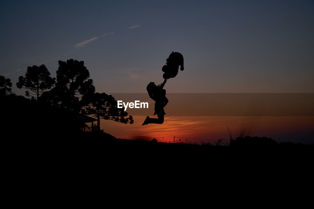 SILHOUETTE AGAINST SKY DURING SUNSET