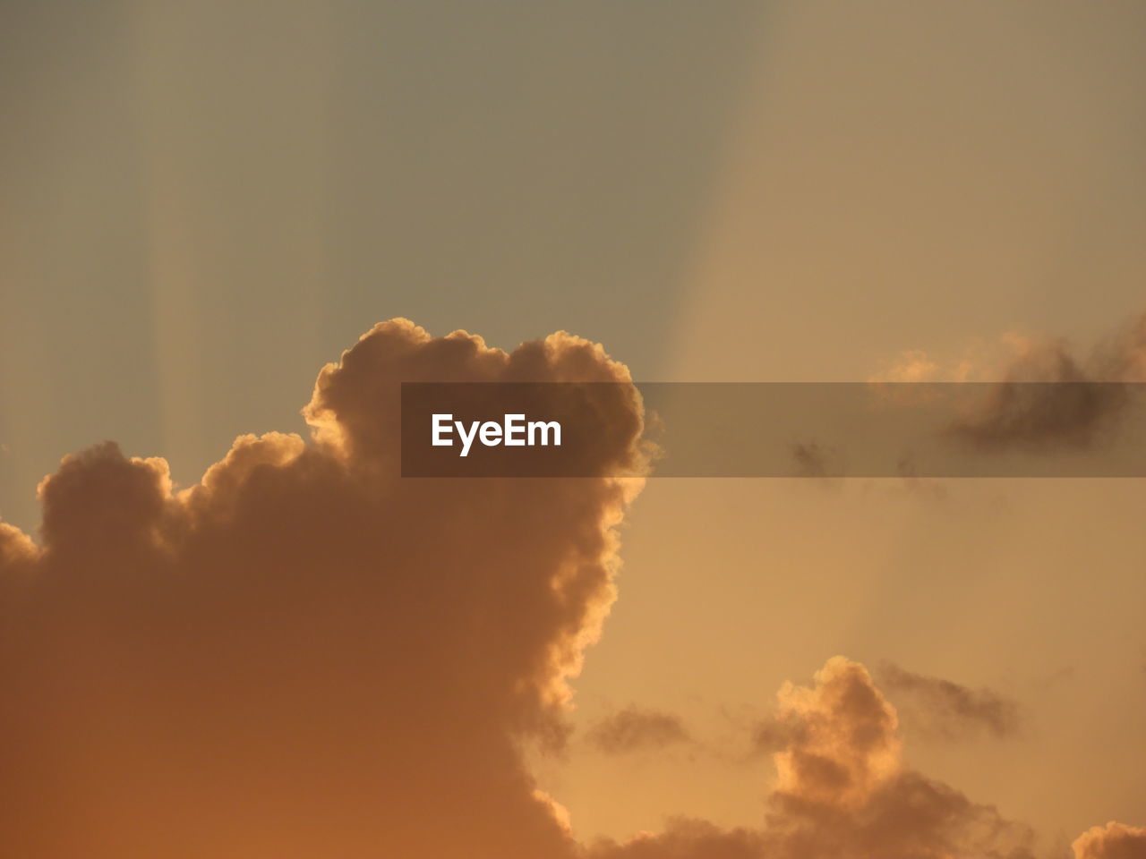 Cloudscape at sunset with sunlight beams of light