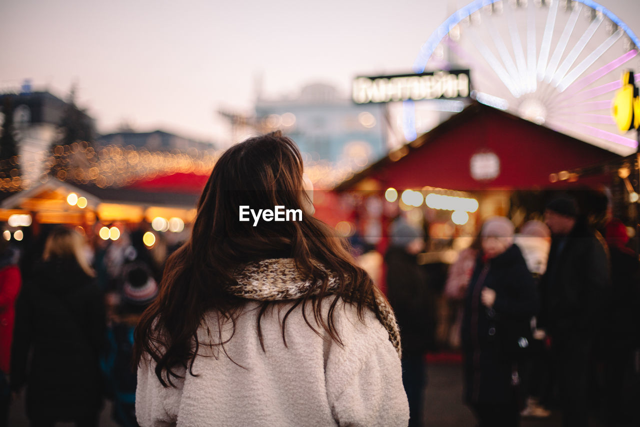 Back view of teenage girl enjoying city during christmas