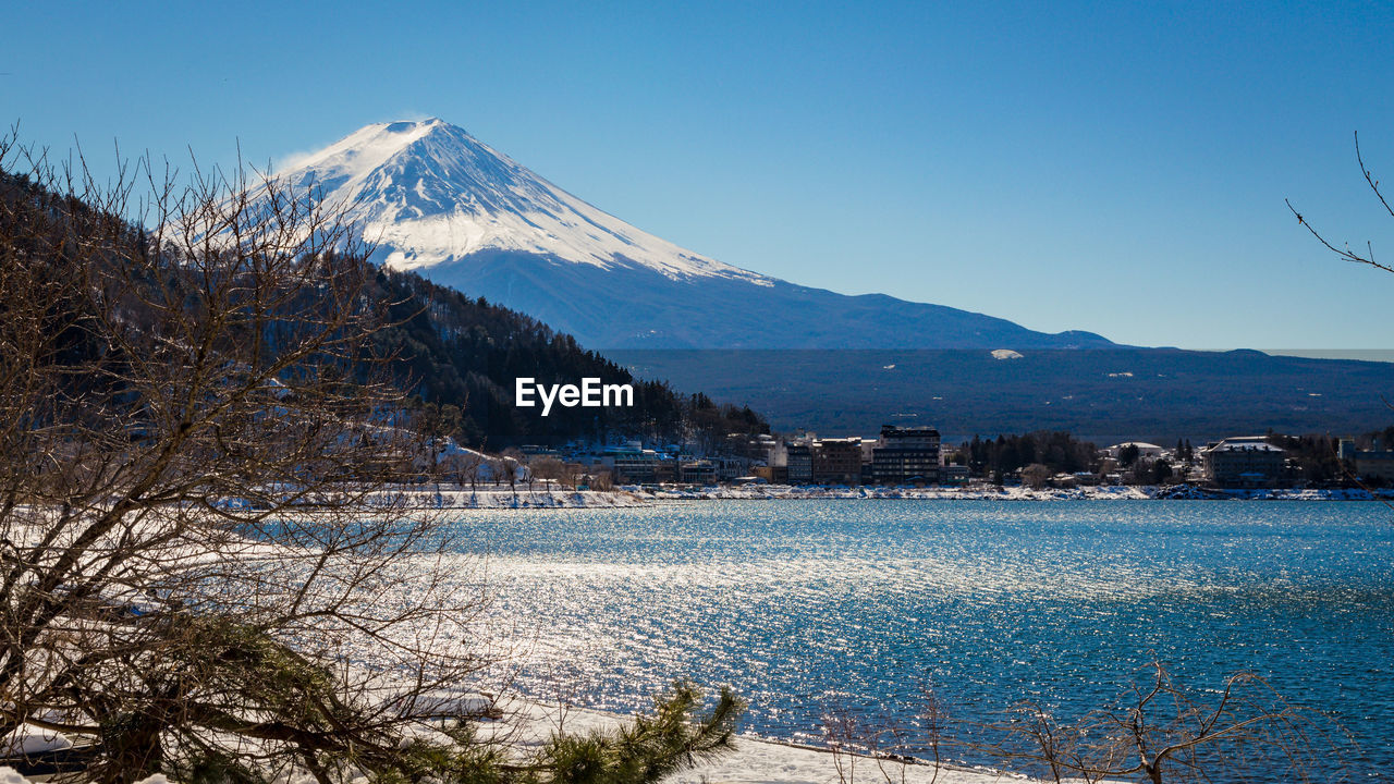 Scenic view of lake kawaguchi and mt fuji against blue sky during winter