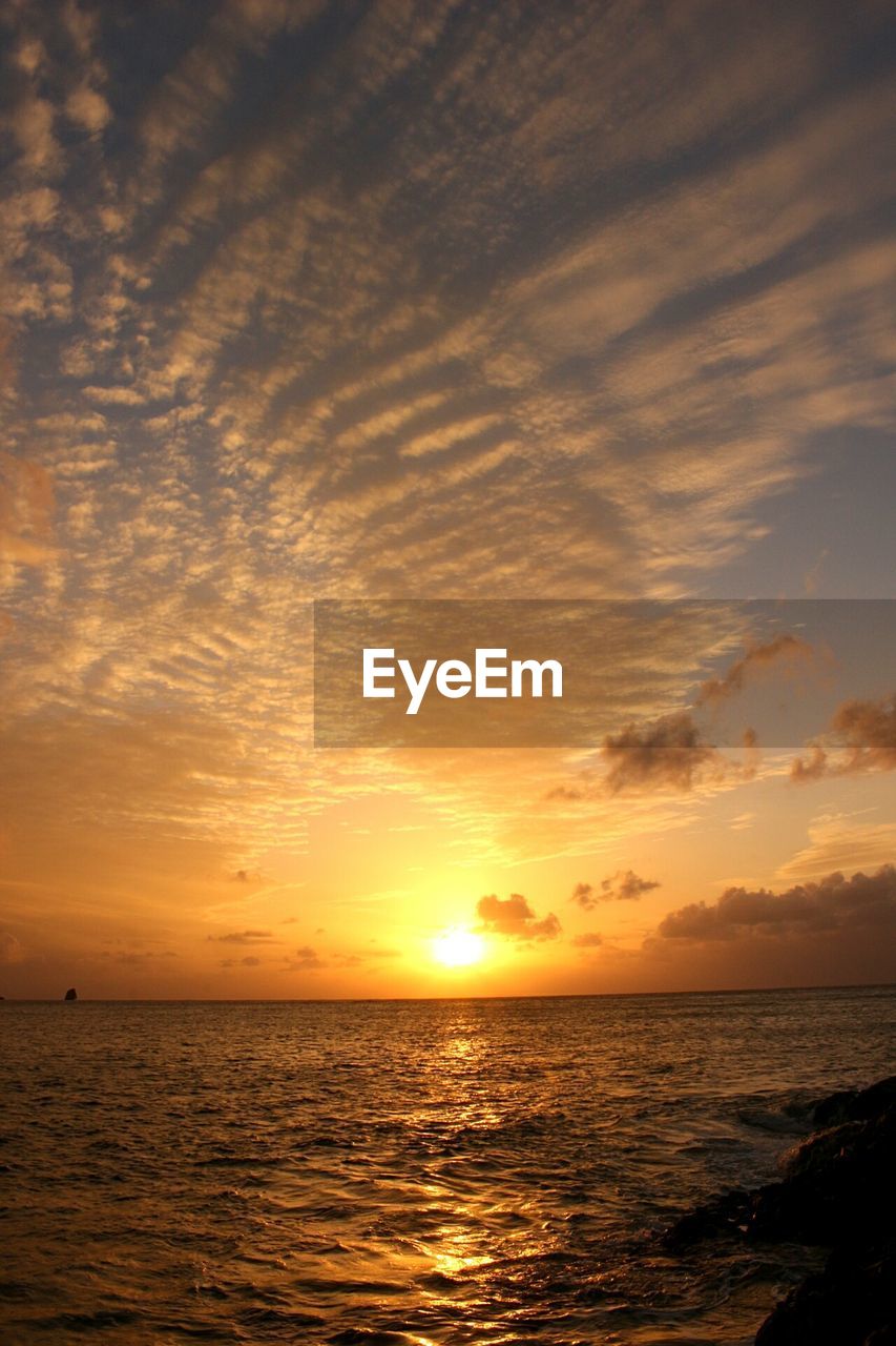 Scenic view of sea against sky at sunset