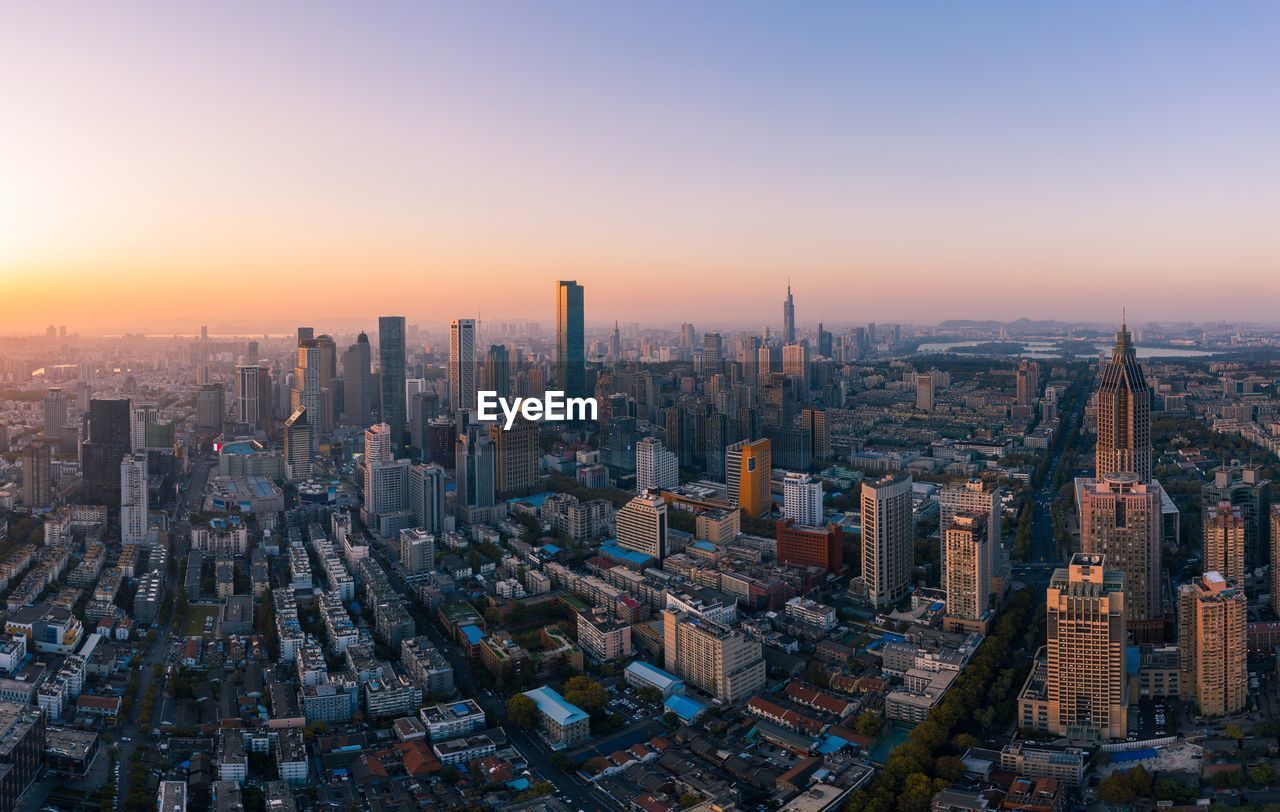 AERIAL VIEW OF BUILDINGS IN CITY AGAINST SKY