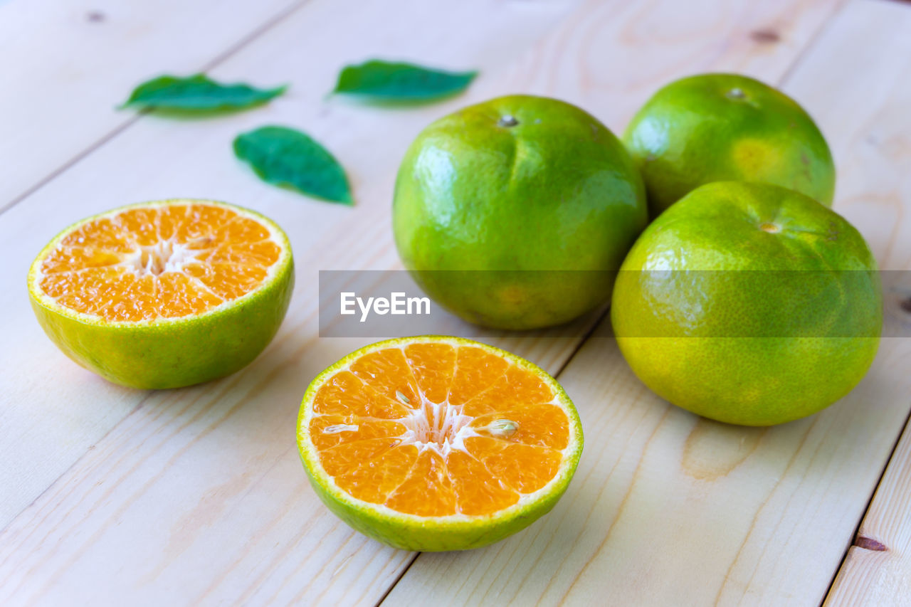 CLOSE-UP OF ORANGE FRUITS ON TABLE