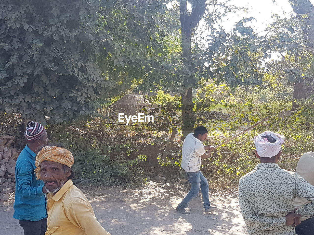 REAR VIEW OF PEOPLE WITH ARMS RAISED