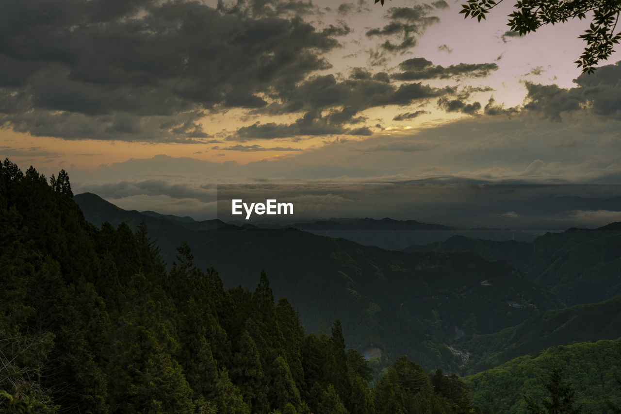 Scenic view of mountains against sky at sunset