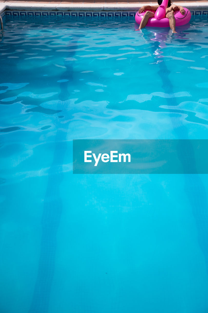 LOW SECTION OF PERSON IN SWIMMING POOL