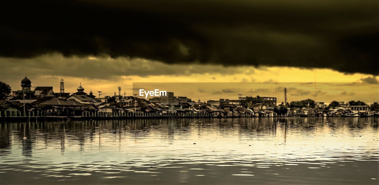 Scenic view of river against sky at sunset