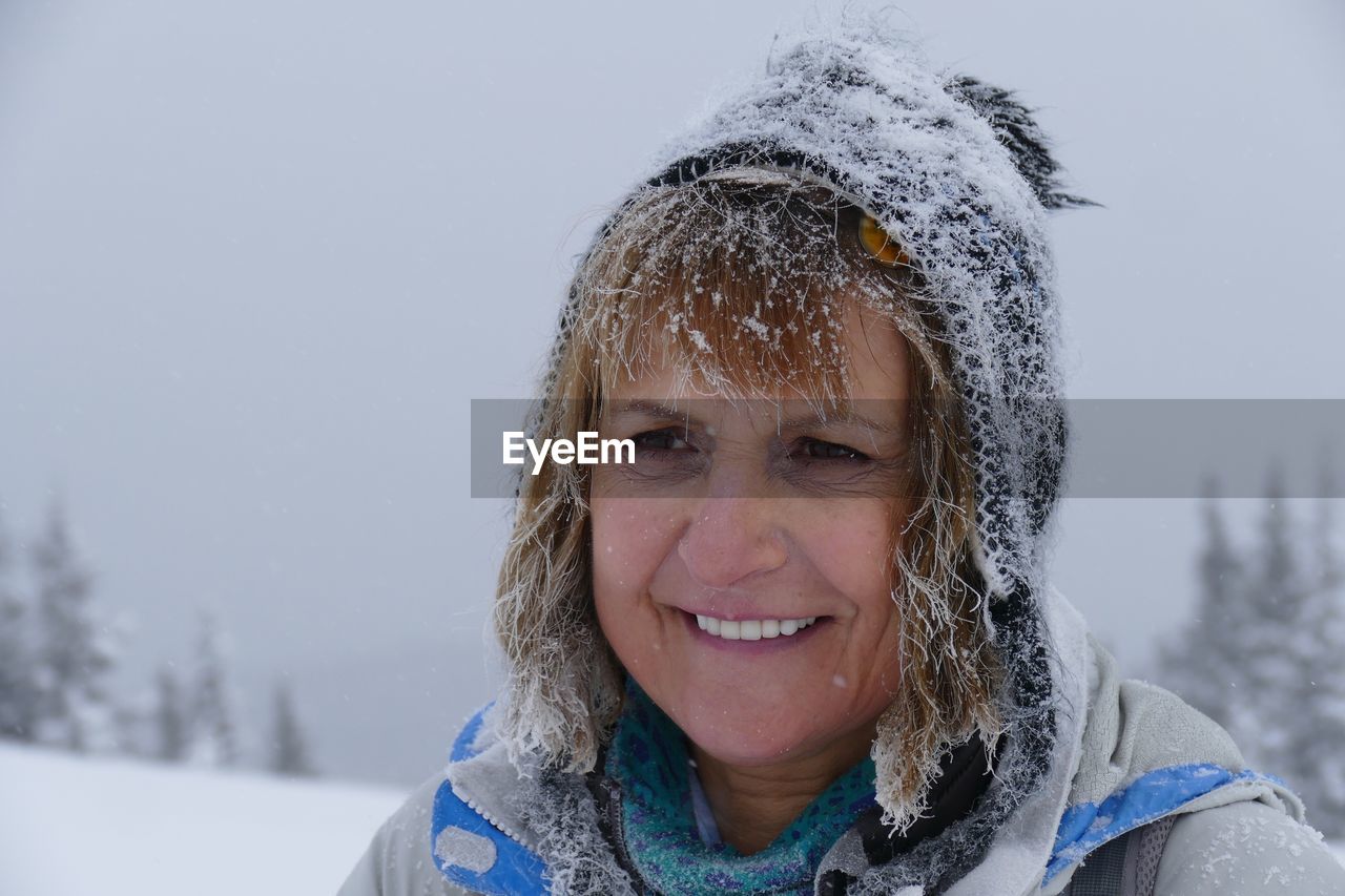 PORTRAIT OF SMILING BOY IN SNOW