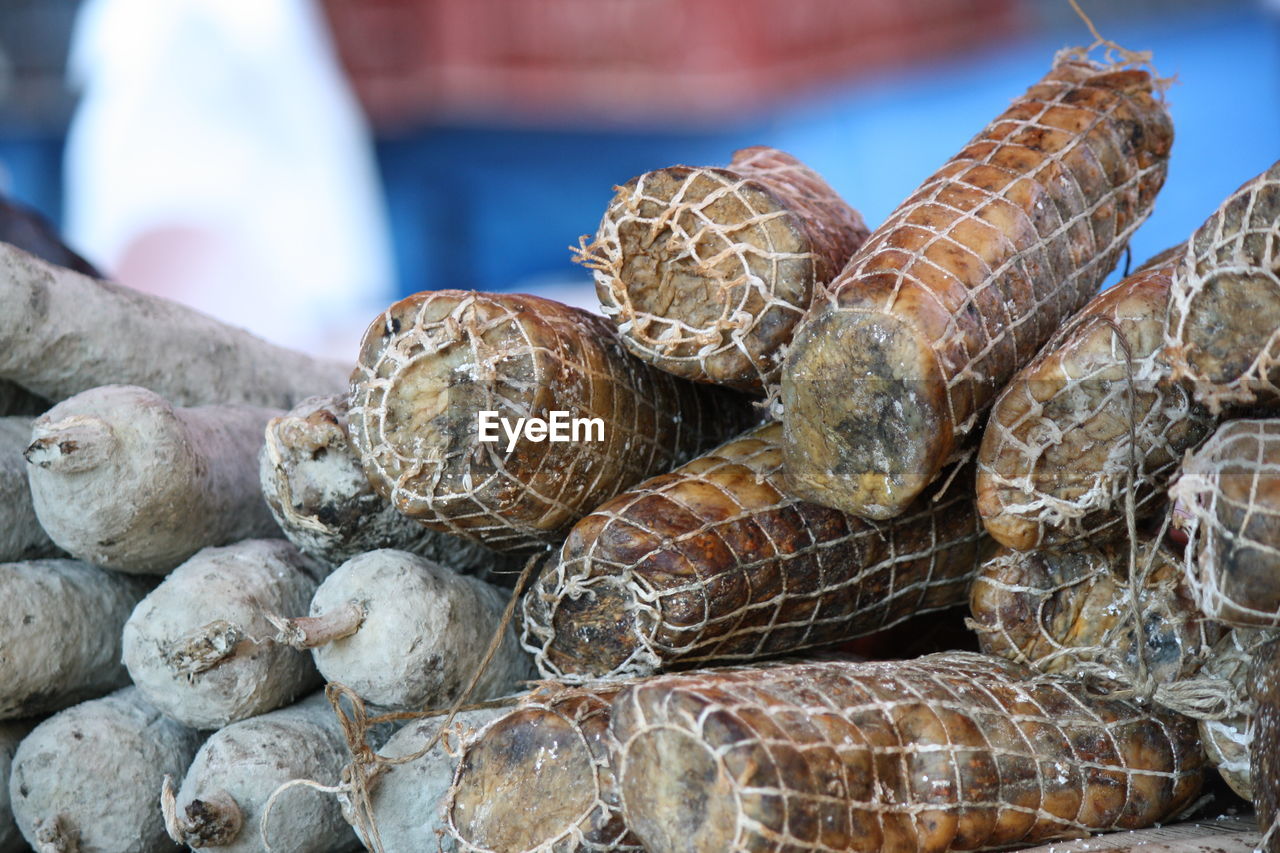 CLOSE-UP OF FIREWOOD FOR SALE AT MARKET STALL