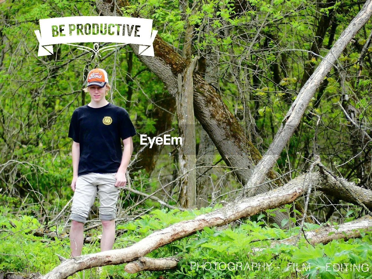 PORTRAIT OF MAN STANDING IN FOREST