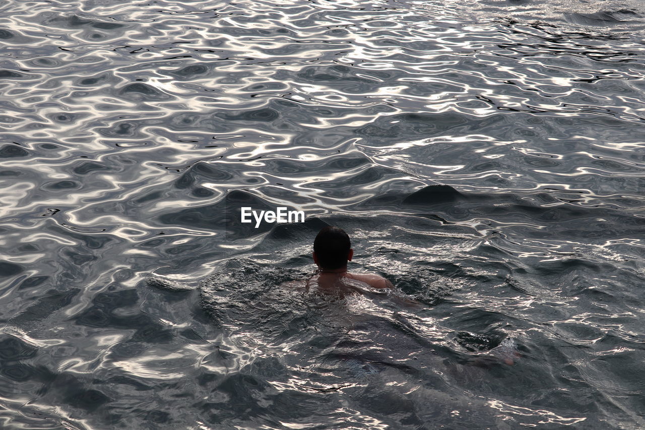 High angle view of man swimming in sea