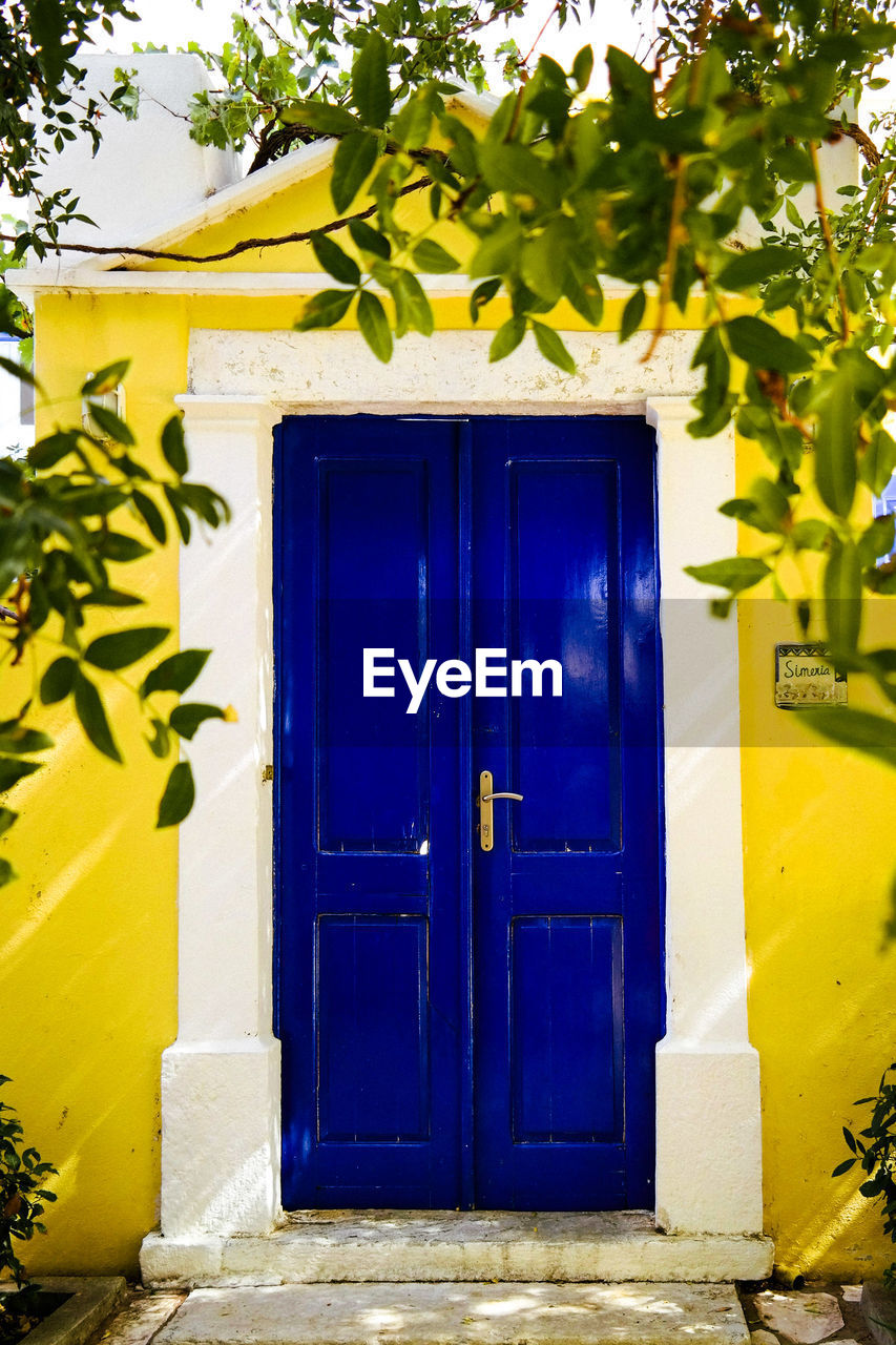 BLUE CLOSED DOOR OF BUILDING