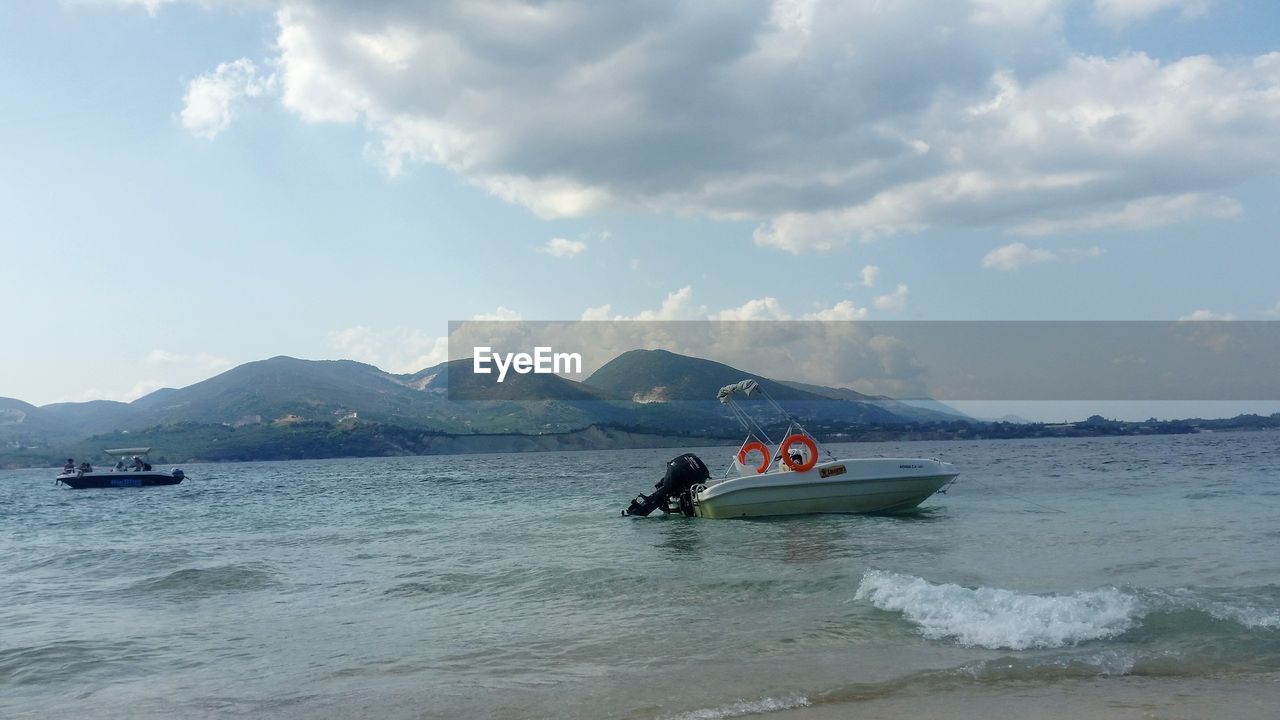 MAN ON BOAT AGAINST SKY